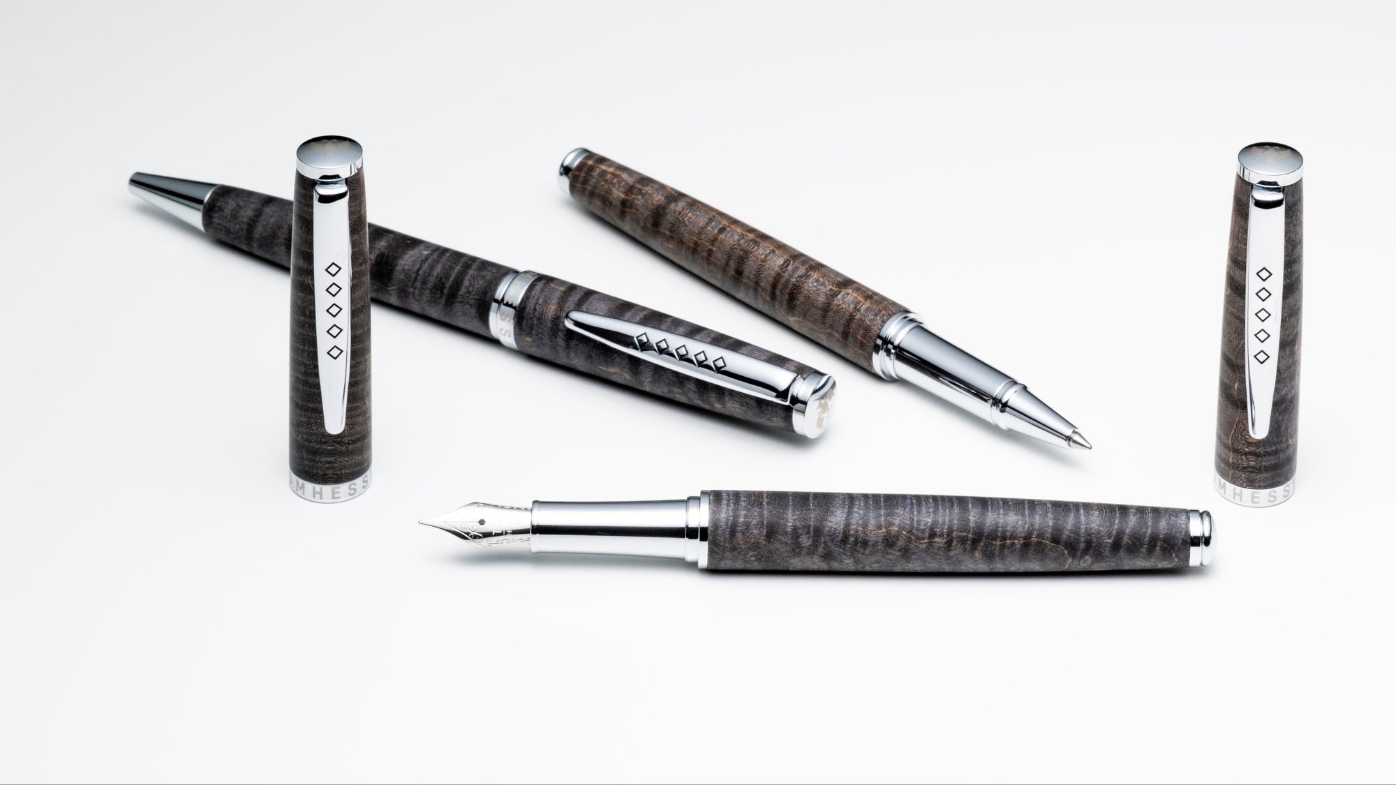 Set of pens with metallic and textured design on a white background