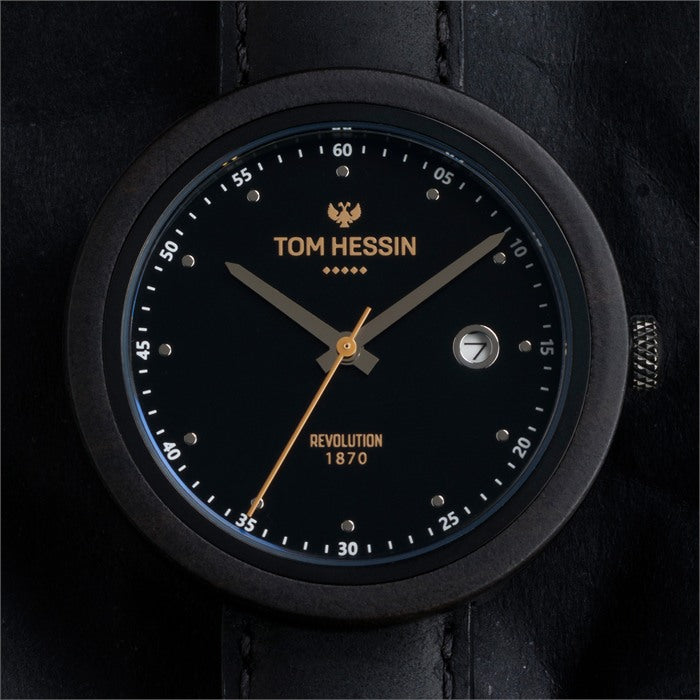 Tom Hessin Revolution Black watch with black leather strap and gold buckle - lifestyle close up