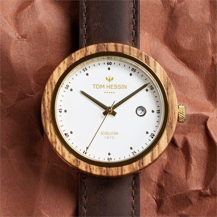 Tom Hessin Revolution Gold watch with brown leather strap and gold buckle - lifestyle close up
