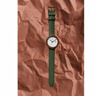 Tom Hessin Revolution Gold watch with green leather strap and gold buckle - lifestyle