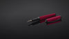 Tom Hessin Magnetic Series Poppy Red fountain pen and cap turning through 360 degrees on black glass
